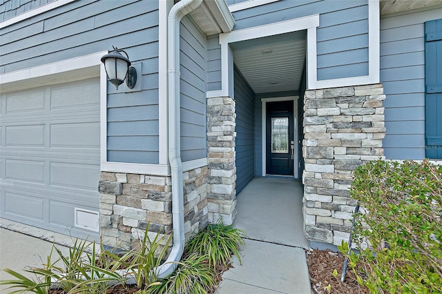 view of exterior entry with a garage