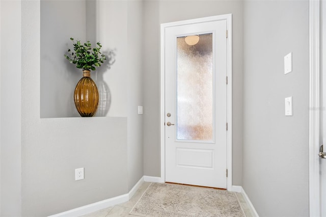 entryway with tile patterned flooring and baseboards