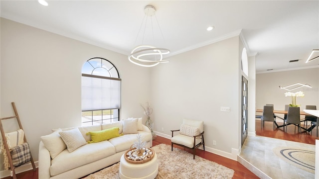 living room featuring hardwood / wood-style floors, a notable chandelier, and ornamental molding