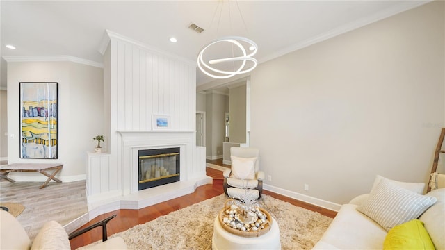 living room with crown molding, a fireplace, and hardwood / wood-style floors