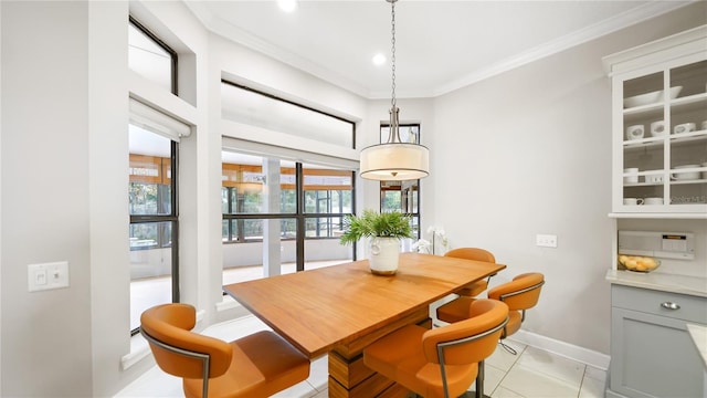 dining area featuring light tile patterned floors and crown molding