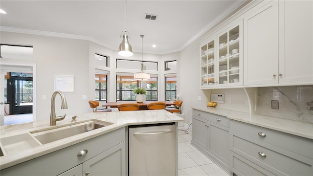 kitchen featuring sink, light tile patterned floors, dishwasher, hanging light fixtures, and ornamental molding