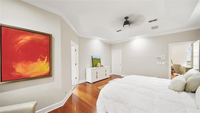 bedroom with ornamental molding, hardwood / wood-style floors, and ceiling fan