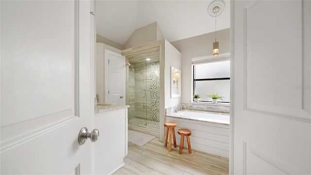 bathroom featuring lofted ceiling and shower with separate bathtub