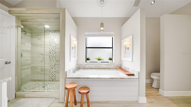 bathroom featuring toilet, plus walk in shower, and hardwood / wood-style floors