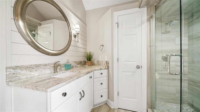 bathroom with vanity and a shower with shower door