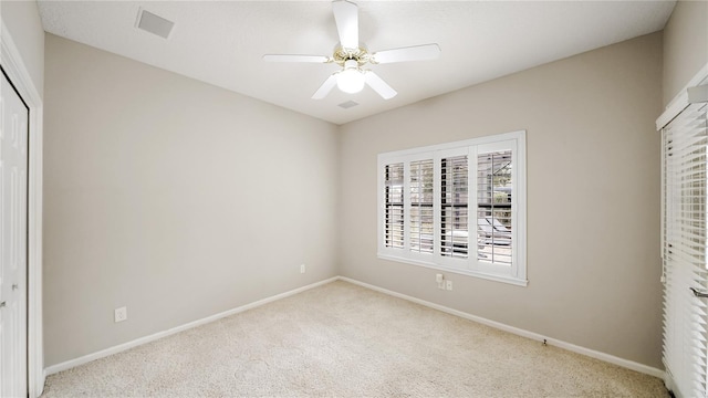 unfurnished bedroom with ceiling fan, light colored carpet, and a closet