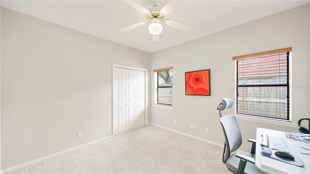 carpeted home office with ceiling fan