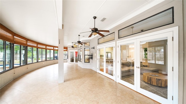 sunroom / solarium featuring french doors