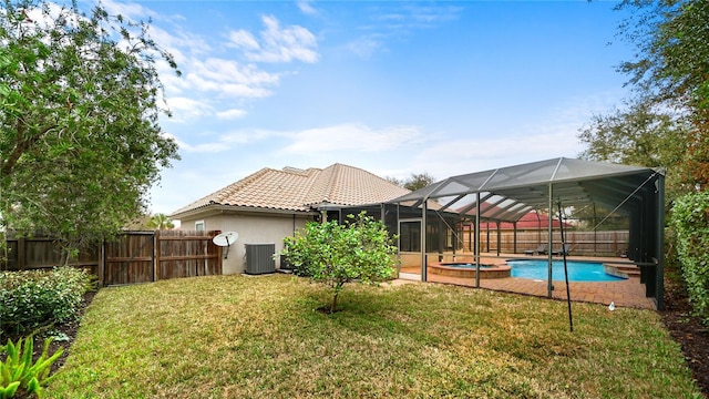 view of yard featuring a fenced in pool and central AC