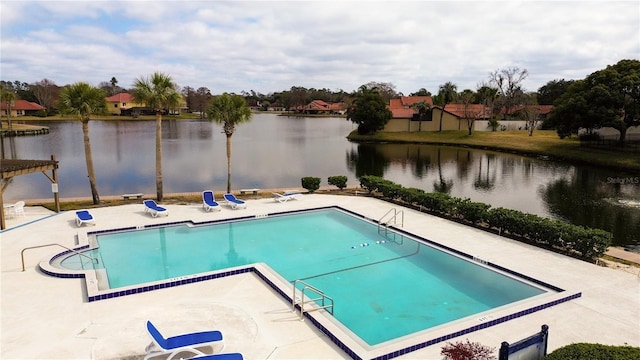 view of pool featuring a water view and a patio area