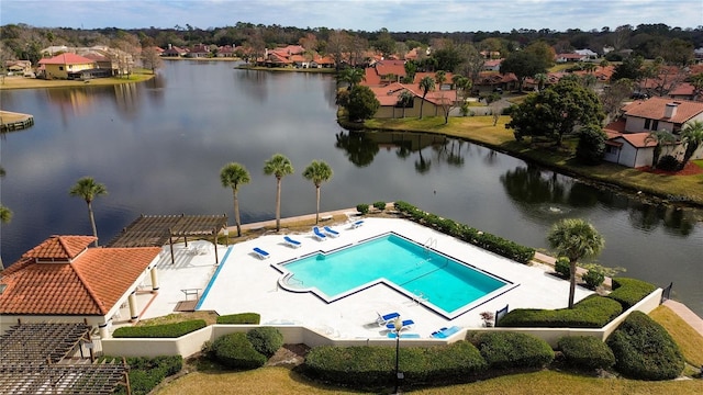 view of swimming pool with a water view and a patio area