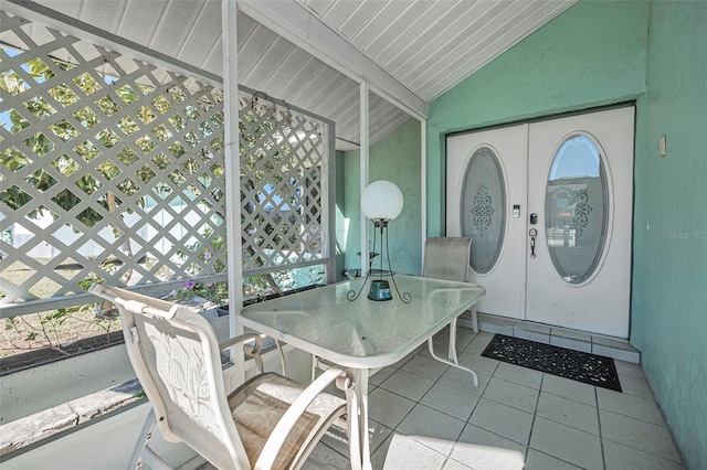 sunroom / solarium with vaulted ceiling and french doors