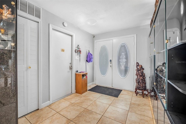 foyer entrance with light tile patterned floors