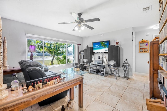 living room with light tile patterned floors and ceiling fan