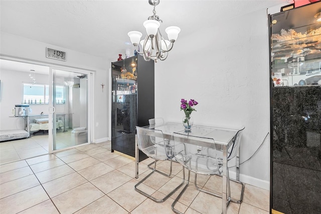 dining space with light tile patterned flooring and an inviting chandelier