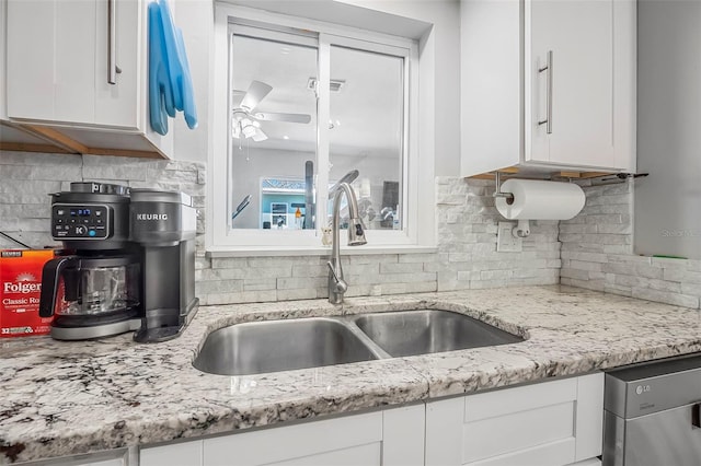 kitchen featuring sink, ceiling fan, dishwasher, white cabinets, and decorative backsplash