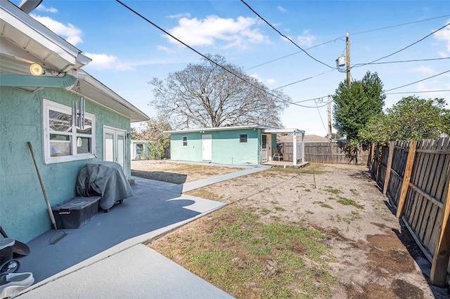 view of yard featuring a patio area and an outdoor structure