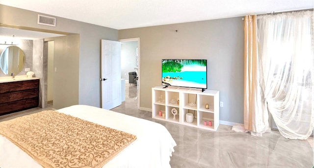 bedroom featuring visible vents, baseboards, and ensuite bathroom