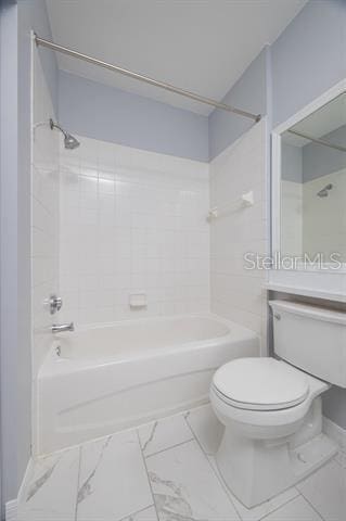 bathroom featuring tiled shower / bath and toilet