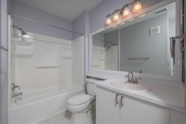 full bathroom featuring vanity, bathtub / shower combination, and toilet