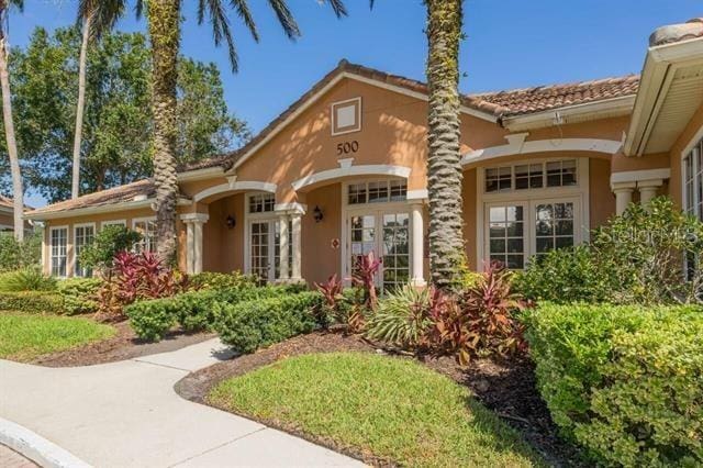 mediterranean / spanish home with french doors