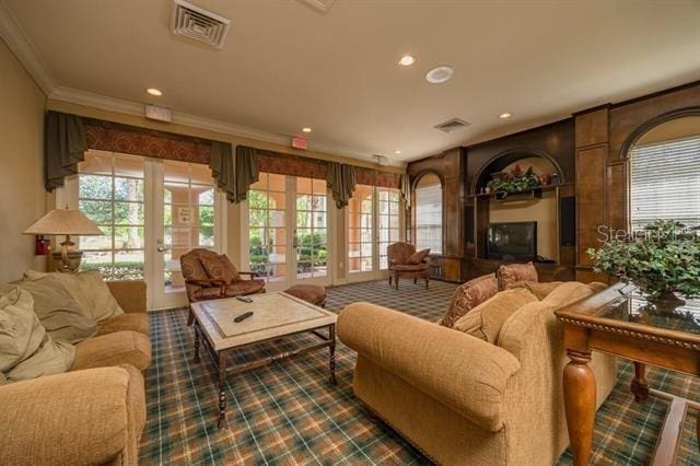 living room featuring crown molding, carpet floors, and french doors