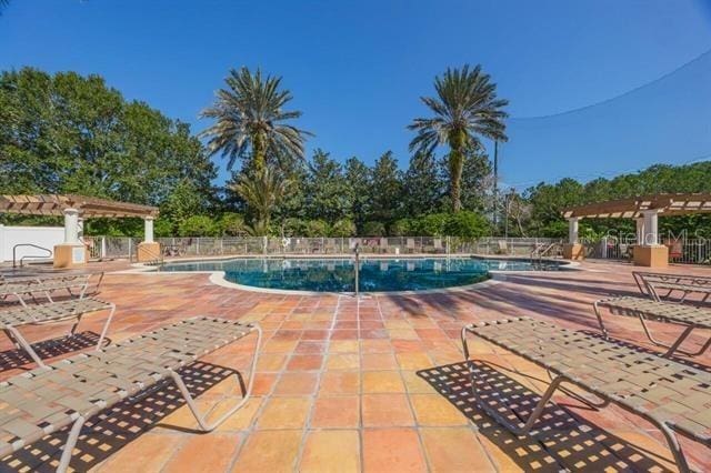 view of swimming pool with a patio and a pergola