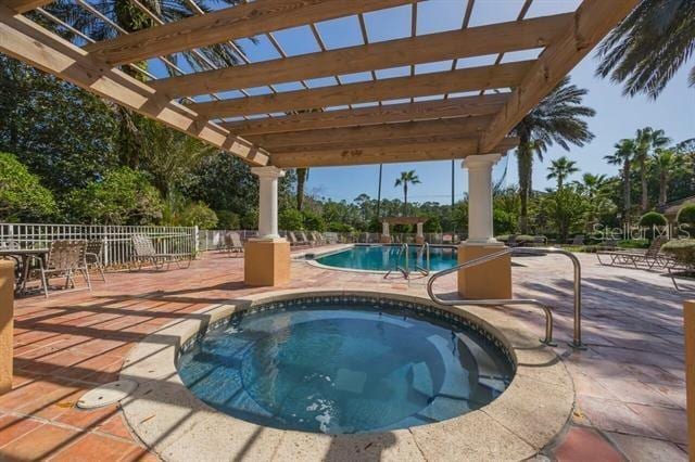 view of pool featuring a patio, a pergola, and a community hot tub