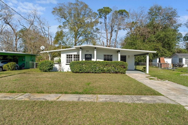 view of front of property featuring driveway, central AC unit, fence, a front lawn, and a carport