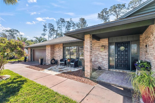 view of exterior entry with a garage