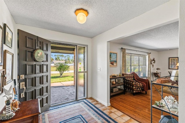 tiled foyer featuring a textured ceiling