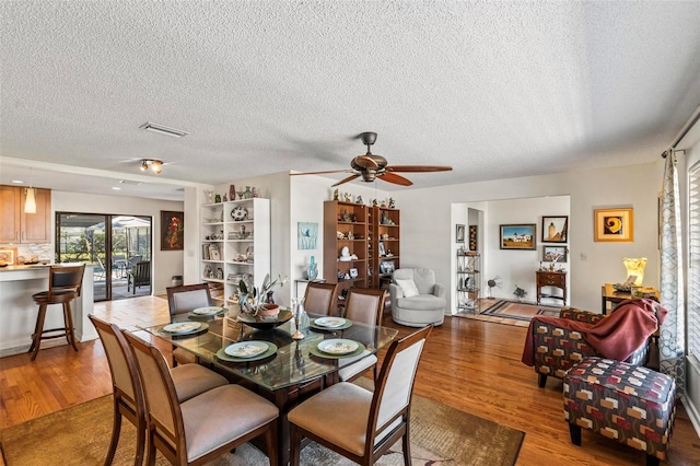 12 Bannerwood Ln, Palm Coast, FL 32137 - dining space featuring wood finished floors, ceiling fan, and a textured ceiling