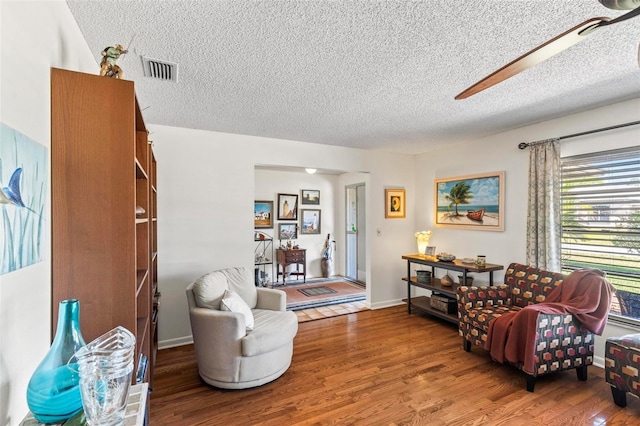 12 Bannerwood Ln, Palm Coast, FL 32137 - living area featuring a textured ceiling, wood finished floors, and ceiling fan