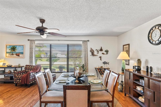 12 Bannerwood Ln, Palm Coast, FL 32137 - dining room featuring light wood-style floors, a ceiling fan, and a textured ceiling