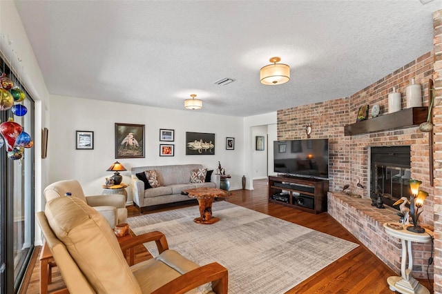 12 Bannerwood Ln, Palm Coast, FL 32137 - living room featuring wood finished floors, a brick fireplace, and a textured ceiling