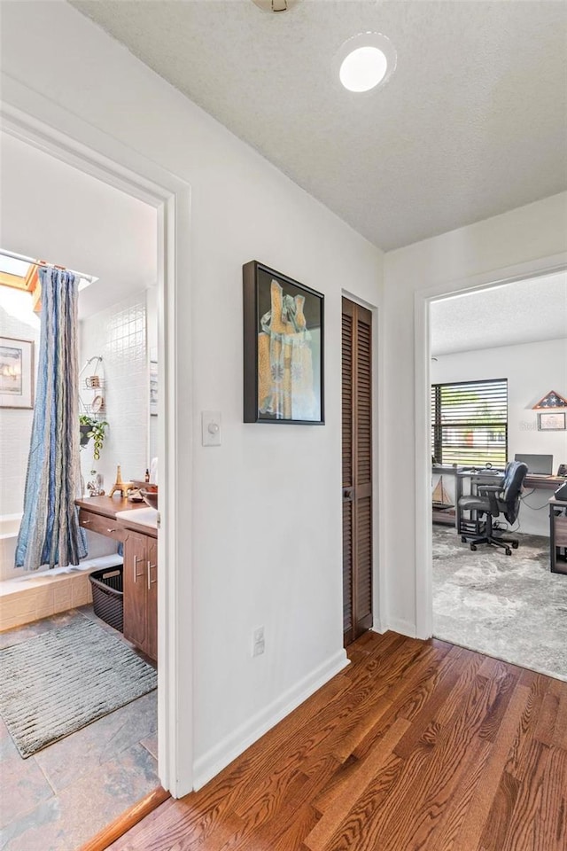 12 Bannerwood Ln, Palm Coast, FL 32137 - hallway featuring an office area and wood finished floors