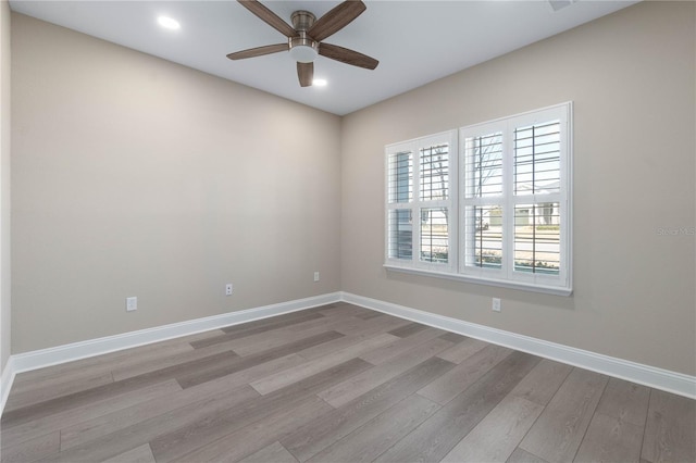 empty room featuring light wood-style floors, baseboards, a ceiling fan, and recessed lighting