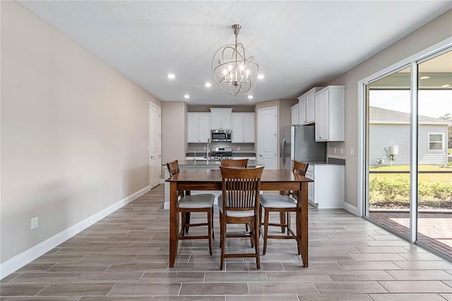 dining room with wood tiled floor, baseboards, and a wealth of natural light