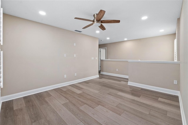 unfurnished room with light wood-type flooring, visible vents, and recessed lighting