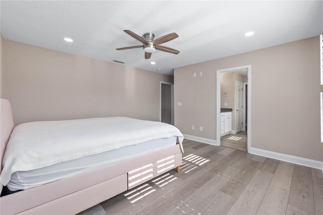 bedroom with recessed lighting, light wood-style flooring, a ceiling fan, ensuite bath, and baseboards