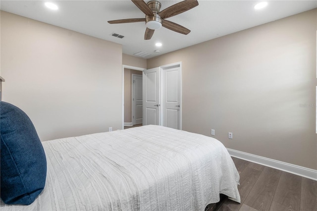 bedroom with baseboards, visible vents, dark wood finished floors, ceiling fan, and recessed lighting