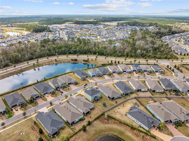 drone / aerial view with a water view and a residential view