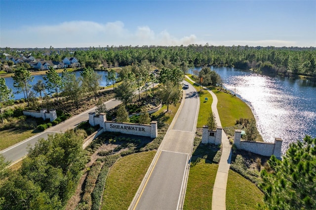 drone / aerial view featuring a water view and a forest view