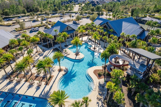 pool with a water slide and a patio area