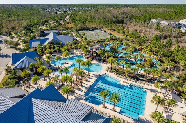 drone / aerial view with a wooded view