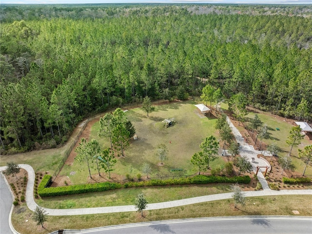 drone / aerial view featuring a forest view