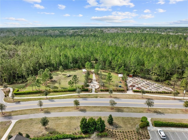 birds eye view of property featuring a forest view