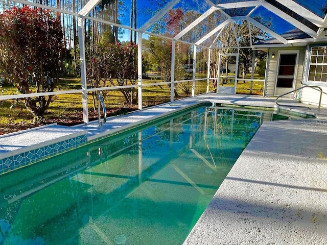 view of swimming pool featuring a lanai and a patio