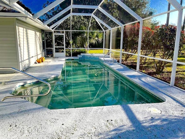 view of pool featuring a patio and glass enclosure